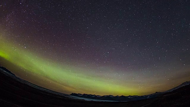 时间流逝-绿色和粉红色的北极光越过山脉视频素材