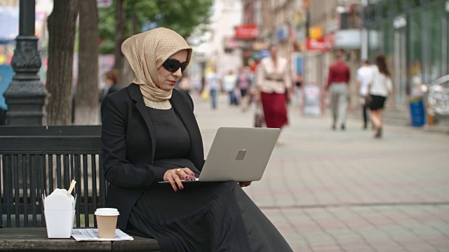 阿拉伯女商人在户外用笔记本电脑工作视频下载