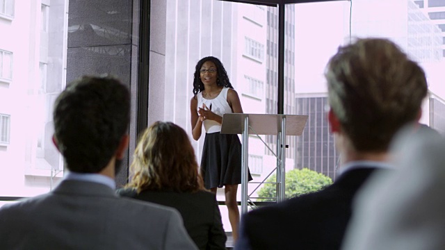 一名年轻的黑人妇女向商业观众展示研讨会，由R3D拍摄视频素材