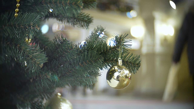 小金镜球。新年和抽象模糊的购物中心背景与圣诞树装饰视频素材