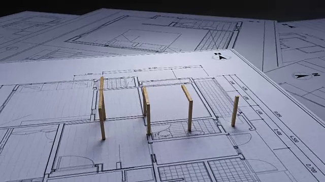 建筑设计图上的木结构房屋制作。视频素材