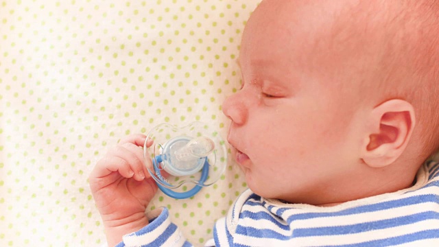 美丽的熟睡的婴儿特写肖像多莉拍摄的手在一个新生婴儿的脸浅景深视频下载
