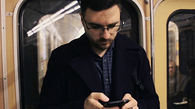用智能手机乘坐地铁的商人视频素材