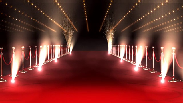 长长的红地毯，聚光灯映衬着红色的背景视频下载