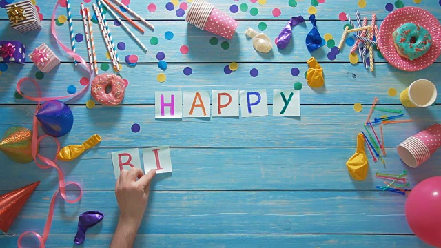 顶视图的人把生日快乐的字样放在桌子上和生日装饰视频素材