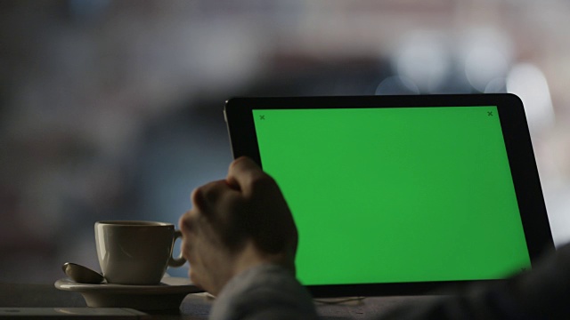 在咖啡厅风景模式下使用绿色屏幕的平板电脑视频素材