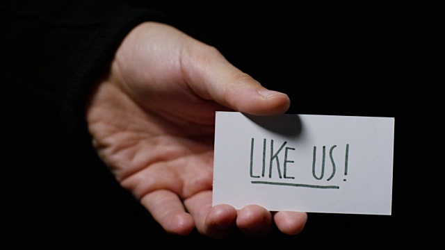 一只手举着一张卡片，上面写着“像我们一样”。经营理念，感谢，记录网站，客户服务，沟通，社交网络，喜欢视频素材
