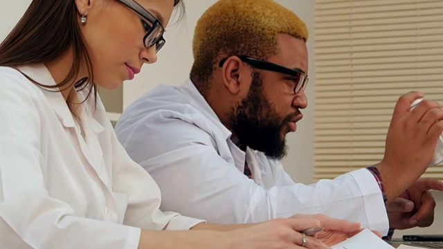 非裔美国男医生和女护士通过电脑上的视频电话开药片视频下载
