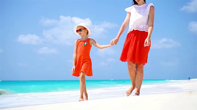可爱的小女孩和年轻的妈妈在热带海滩视频素材