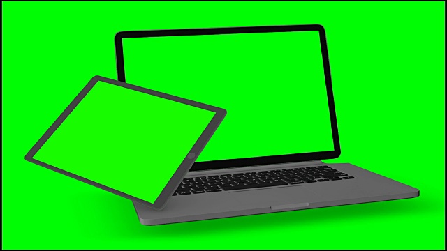 4 k的视频。笔记本电脑和平板电脑在绿色背景下绿色屏幕启动。视频素材