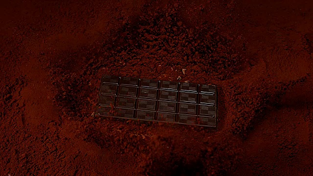 巧克力平板落在黑巧克力粉上，4K慢镜头视频下载