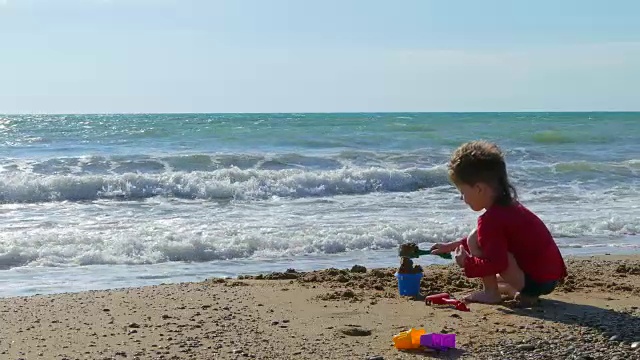 男孩在沙滩上玩沙子视频下载