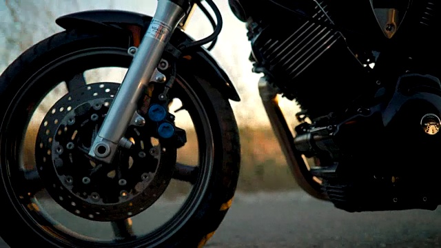 日落时分，摩托车手在空旷的路上骑着摩托车视频下载