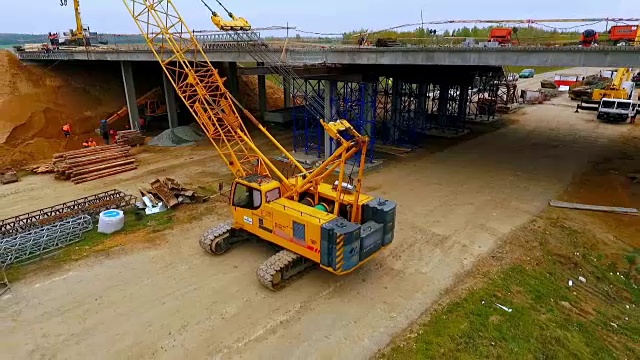 桥梁施工。高速公路上履带式起重机修复桥的天空视图视频下载