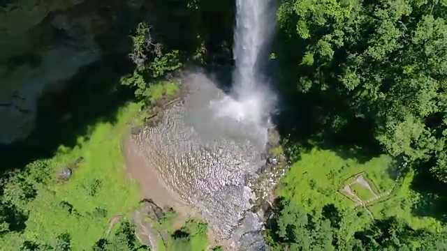 彩虹围绕巨大的瀑布喷雾在水池空中上升镜头视频素材