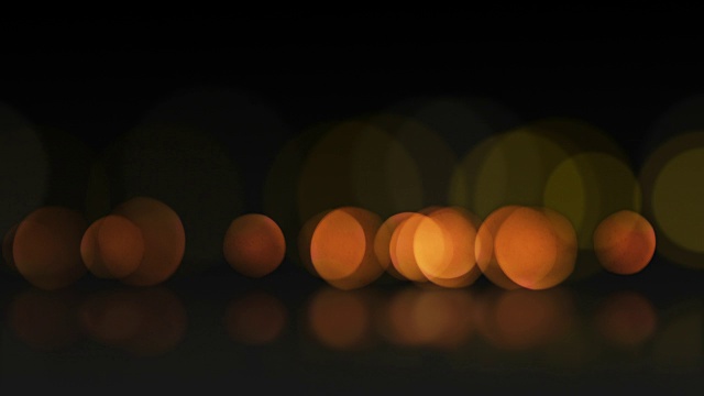 无缝循环抽象运动背景。散焦或散焦橙色粒子和反射的动画。视频素材