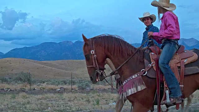 两个朋友骑马在犹他州黄昏的实时视频视频素材