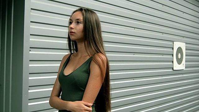 一个迷人的女人穿着性感的衣服站在街上视频素材