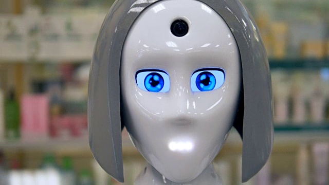 一个新的闪亮的机器人用它的蓝色大眼睛眨着眼睛。视频素材