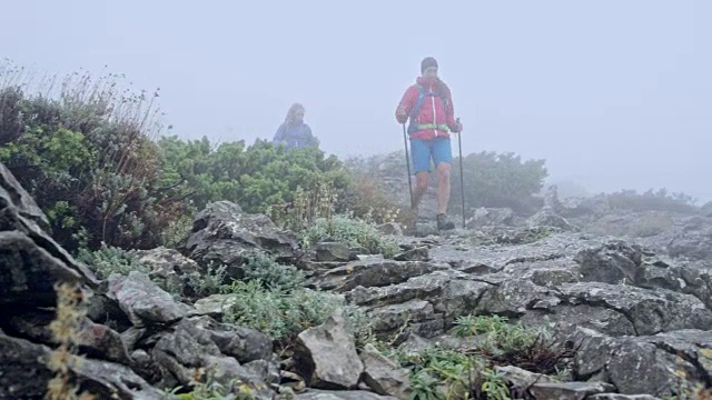 两个女性朋友在浓雾中徒步下山视频素材