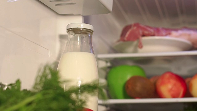 冰箱货架上的一瓶牛奶的特写视频素材