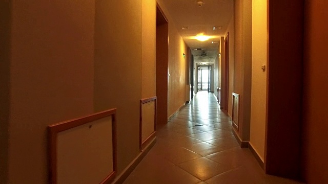 逃离步行pov进入酒店的长走廊的视角，4k稳定器拍摄视频素材