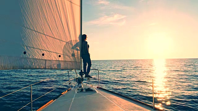 在帆船上欣赏日落的女人视频素材