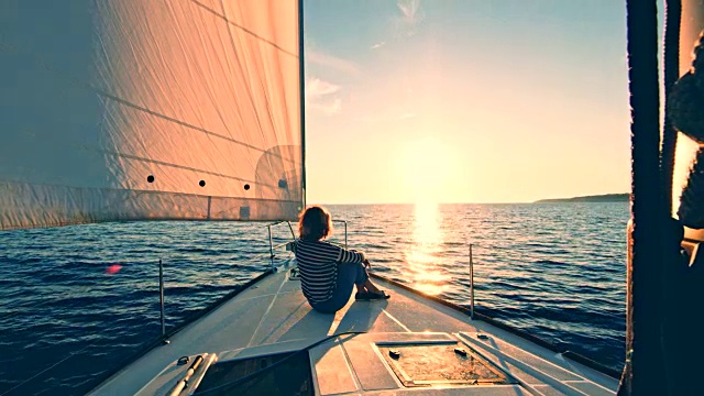 一个女人在船上欣赏日落视频素材