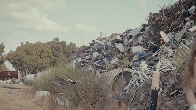 拯救地球。孩子们举着牌子站在一个巨大的垃圾场里视频素材