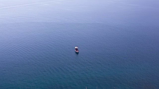 小船在开阔的海面上和周围的人游泳视频素材