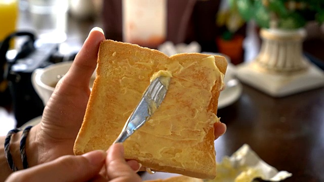 手拿着面包和黄油做早餐视频下载