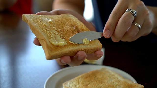 手拿着面包和黄油做早餐视频下载