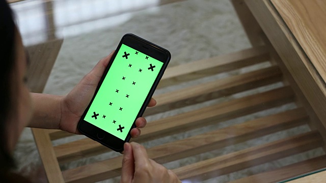 男性手持绿色屏幕智能手机的特写视频素材