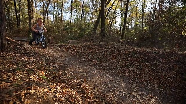 小男孩在大自然中骑自行车视频素材
