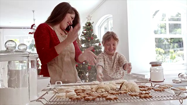 顽皮的妈妈和女儿在做圣诞饼干视频素材