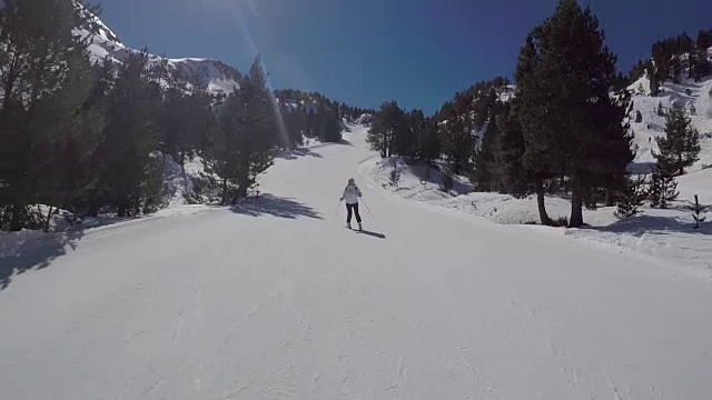 那个女人正在山上的滑雪场滑雪。视频素材