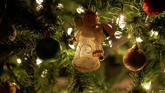 仙子花环和圣诞球装饰在树上与散焦灯视频素材