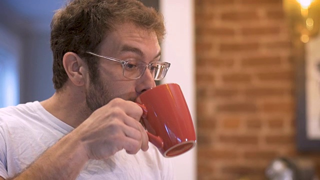 有魅力的男人在早上喝咖啡，然后吞咽视频素材
