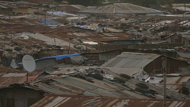 在塞拉利昂凯内马，风吹起了用来修补瓦楞铁皮房屋屋顶的防水布。视频下载