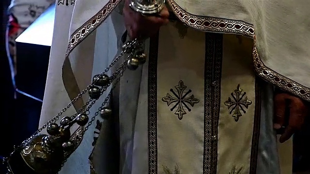 一个神父在东正教教堂摇摆瑟曼的特写，慢动作视频下载