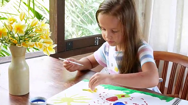 这个女孩画了一个调色板的水彩颜料。水彩画创作水彩画的过程视频素材