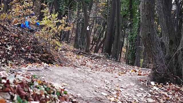 慢动作视频的摩托车骑他的山地车通过森林视频素材