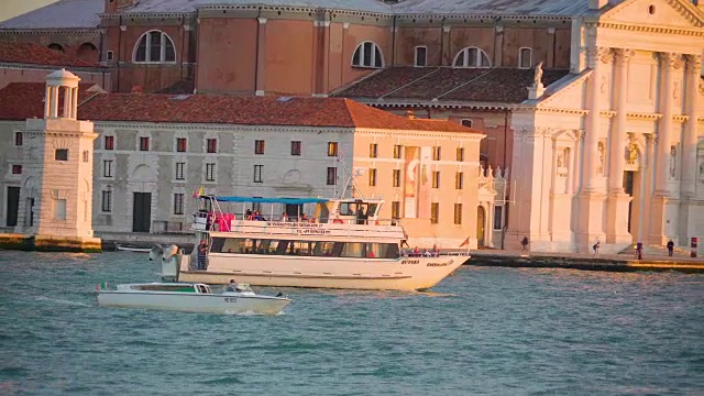 一只小船和一只小快艇在意大利威尼斯的大运河上游弋视频下载