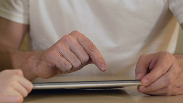 父亲和女儿在平板电脑上搜索新的教育应用程序视频下载