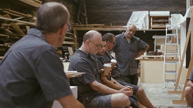 木匠们在喝咖啡休息(慢镜头)视频素材