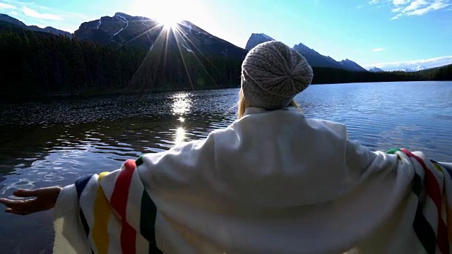 快乐的年轻女子在加拿大的山湖边放松视频下载
