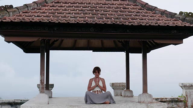 在废弃的寺庙里冥想和做瑜伽的女人视频下载