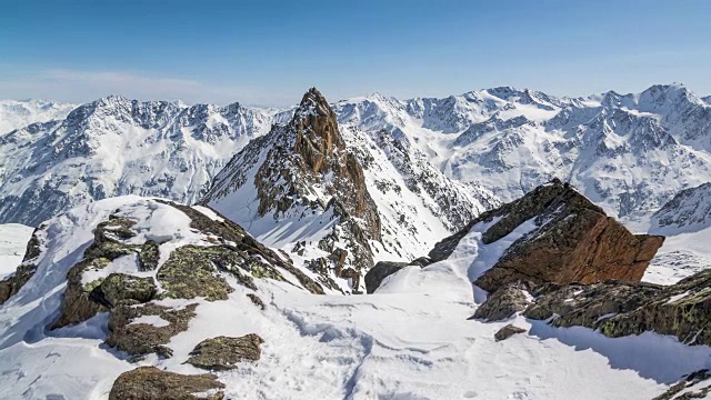 美丽的阳光明媚的冬日在雪山阿尔卑斯山。时光流逝摄影在雪山和雄伟的山峰上拍摄视频素材