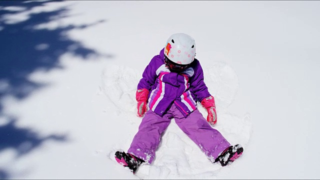 年轻的白人女孩穿着滑雪服玩雪视频下载