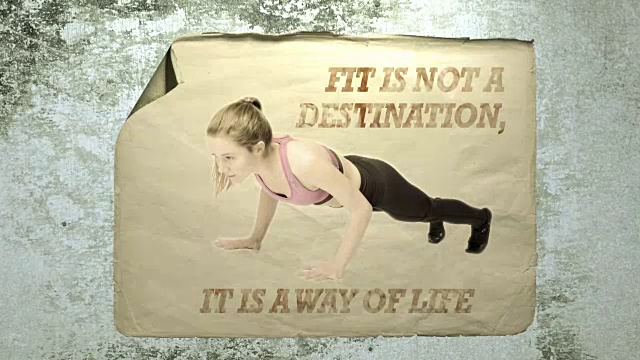 水泥墙上的旧纸广告上有一个年轻的女运动员的肖像和题词，适合不是一个目的地，它是一种生活方式。模仿相机抖动和闪光灯。视频下载
